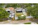An aerial back view of a home with a screened-in porch and white fence at 621 89Th N Ave, St Petersburg, FL 33702