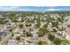 Aerial view of home with address label in St. Petersburg, FL in a tree-lined neighborhood at 621 89Th N Ave, St Petersburg, FL 33702