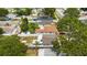 Aerial view of multiple rooftops among shady trees shows the yards and nearby street access at 621 89Th N Ave, St Petersburg, FL 33702