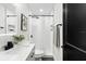 Bright bathroom featuring a sleek vanity, modern fixtures, and tiled shower with patterned floor at 621 89Th N Ave, St Petersburg, FL 33702