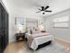 Cozy bedroom showcasing a plush bed, neutral decor, and a stylish ceiling fan at 621 89Th N Ave, St Petersburg, FL 33702