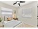 Comfortable bedroom with twin bed, ceiling fan, natural light, and neutral decor for a cozy space at 621 89Th N Ave, St Petersburg, FL 33702