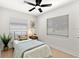Cozy bedroom with a twin bed, bright walls, a ceiling fan, and natural light from the window at 621 89Th N Ave, St Petersburg, FL 33702