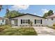 Inviting single-story home with a fresh lawn and black shutters at 621 89Th N Ave, St Petersburg, FL 33702