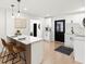 Open kitchen design with a breakfast bar, light wood floors, and modern pendant lighting at 621 89Th N Ave, St Petersburg, FL 33702