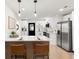 Modern kitchen featuring an island with seating, stainless steel appliances, and sleek cabinetry at 621 89Th N Ave, St Petersburg, FL 33702