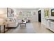 Bright living room with modern furnishings and wood-look tile floors at 621 89Th N Ave, St Petersburg, FL 33702