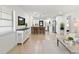 Bright living room featuring wood floors, open layout, and large windows that provide abundant natural light at 621 89Th N Ave, St Petersburg, FL 33702