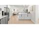 Open living space showcasing an island with seating and stainless steel appliances, blending style and functionality at 621 89Th N Ave, St Petersburg, FL 33702