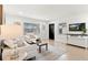 Bright living room with modern furnishings and wood-look tile floors at 621 89Th N Ave, St Petersburg, FL 33702