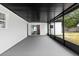 A screened-in back porch with a black frame, siding, and a door leading into the home at 621 89Th N Ave, St Petersburg, FL 33702