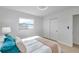 Sunlit bedroom features sleek hardwood floors, a modern ceiling fan, and a spacious closet for ample storage at 6738 Criswell N Ave, St Petersburg, FL 33709