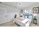 Cozy bedroom featuring stylish lamps, beach-themed wall art, and plenty of natural light from the windows at 6738 Criswell N Ave, St Petersburg, FL 33709