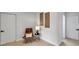 Stylish hallway with accent chair and modern artwork, offering a cozy and inviting transition space at 6738 Criswell N Ave, St Petersburg, FL 33709