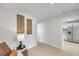 Bright hallway with views into the kitchen, modern artwork, and wood floors adding a touch of elegance at 6738 Criswell N Ave, St Petersburg, FL 33709