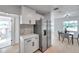 Open kitchen layout with stainless steel refrigerator and adjacent dining area at 6738 Criswell N Ave, St Petersburg, FL 33709