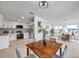Open-concept living room with modern kitchen and dining area, featuring wood floors and bright, neutral decor at 6738 Criswell N Ave, St Petersburg, FL 33709