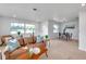 Open-concept living room featuring hardwood floors, comfortable seating, and a dining area at 6738 Criswell N Ave, St Petersburg, FL 33709