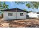 A rear view of the property showing a well-maintained exterior and access to the backyard at 6738 Criswell N Ave, St Petersburg, FL 33709