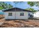 Image displaying the back of the home with a freshly painted exterior, offering a serene view at 6738 Criswell N Ave, St Petersburg, FL 33709