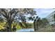 Building exterior overlooking the lake, highlighted by mature trees, offering a serene view and natural light at 701 S Madison Ave # 515, Clearwater, FL 33756