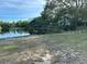 Scenic lake view showcasing the tranquil waters surrounded by lush greenery and a clear blue sky at 701 S Madison Ave # 515, Clearwater, FL 33756