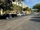 Well-maintained parking lot in front of the building, surrounded by trees and parked cars at 701 S Madison Ave # 515, Clearwater, FL 33756
