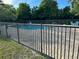 Community pool area featuring a fenced-in swimming pool, a paved deck, and comfortable lounge chairs at 701 S Madison Ave # 515, Clearwater, FL 33756