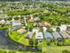 Gorgeous aerial view of a serene community with beautiful homes, lush greenery, and tranquil water features at 7114 Cromwell Park Ln, Apollo Beach, FL 33572