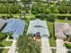 Stunning aerial view of a beautiful home with lush landscaping, a well-manicured lawn, and mature trees at 7114 Cromwell Park Ln, Apollo Beach, FL 33572
