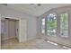 Bright bedroom with tiled floors, large windows, and convenient access to a side room at 7114 Cromwell Park Ln, Apollo Beach, FL 33572