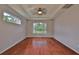 Large bedroom with hardwood floors, a ceiling fan, and ample natural light at 7114 Cromwell Park Ln, Apollo Beach, FL 33572