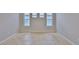 Neutral bedroom with tiled floors and plenty of natural light from three windows at 7114 Cromwell Park Ln, Apollo Beach, FL 33572