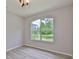 Bright bedroom with laminate flooring, with window overlooking backyard at 7114 Cromwell Park Ln, Apollo Beach, FL 33572