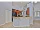 Well-equipped kitchen features dark wood cabinetry and a breakfast bar at 7114 Cromwell Park Ln, Apollo Beach, FL 33572