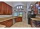 Kitchen with wood cabinets, stainless appliances, and a view into the living room at 7114 Cromwell Park Ln, Apollo Beach, FL 33572