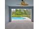 Covered lanai offers tranquil views of the sparkling pool and lush landscaping at 7114 Cromwell Park Ln, Apollo Beach, FL 33572