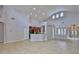 Spacious living room featuring tile floors, vaulted ceilings, and an open layout to kitchen at 7114 Cromwell Park Ln, Apollo Beach, FL 33572