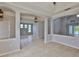 Open living area with tiled floors, decorative columns, and plenty of natural light at 7114 Cromwell Park Ln, Apollo Beach, FL 33572
