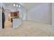 Living room with tile flooring, high ceilings, and an archway to the kitchen at 7114 Cromwell Park Ln, Apollo Beach, FL 33572