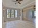 Spacious living room featuring tiled floors, arched windows, and elegant lighting fixtures at 7114 Cromwell Park Ln, Apollo Beach, FL 33572