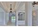 Elegant living room with tiled floors, decorative columns, and a view of the screened-in pool at 7114 Cromwell Park Ln, Apollo Beach, FL 33572