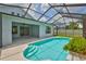 Screened-in pool area with bright blue water and a covered patio, perfect for outdoor relaxation at 7114 Cromwell Park Ln, Apollo Beach, FL 33572