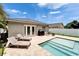 Backyard pool featuring a stone patio, outdoor grill, and lounge furniture; great for entertaining and relaxation at 719 58Th S St, Gulfport, FL 33707