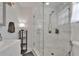 Bathroom featuring a glass-enclosed shower with marble-look tiles, modern fixtures, and ample lighting at 719 58Th S St, Gulfport, FL 33707