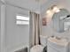Bathroom showcasing a tub with shower, modern fixtures, and clean, bright lighting at 719 58Th S St, Gulfport, FL 33707