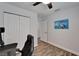 Bedroom featuring wood-look floors, a ceiling fan, and a large closet at 719 58Th S St, Gulfport, FL 33707
