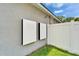 The property features exterior mounted equipment next to a white vinyl fence and green grass at 719 58Th S St, Gulfport, FL 33707