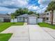 Charming single-story home featuring a well-manicured front lawn, driveway, and an attached one-car garage at 719 58Th S St, Gulfport, FL 33707