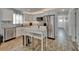 Modern kitchen featuring stainless steel appliances, white cabinets, granite countertops, a mosaic backsplash, and eat-in table at 719 58Th S St, Gulfport, FL 33707